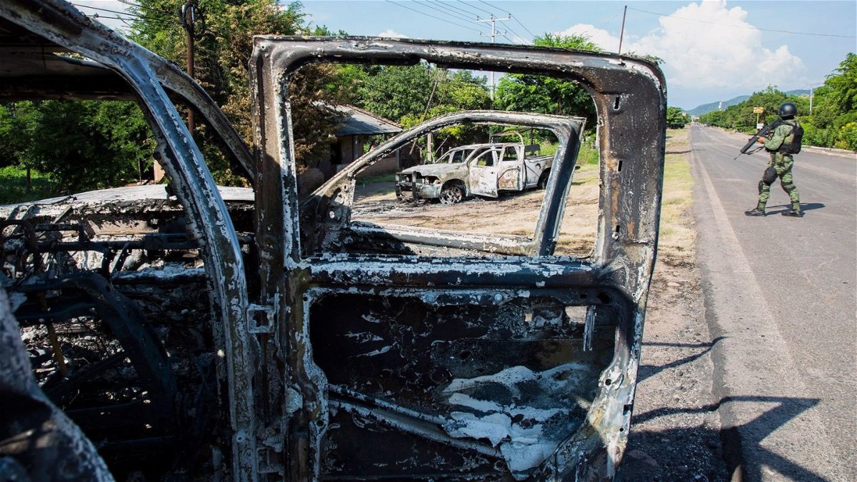 Burned out vehicles from a recent drug cartel ambush of Mexican authorities.