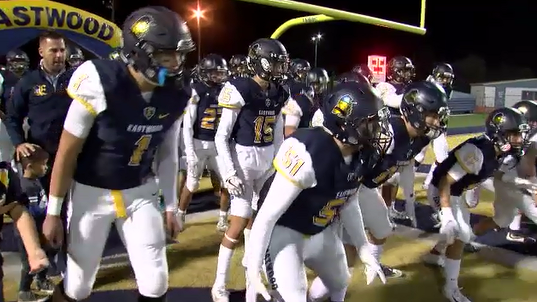 The Eastwood High School football team prepares to take the field at a game last season.
