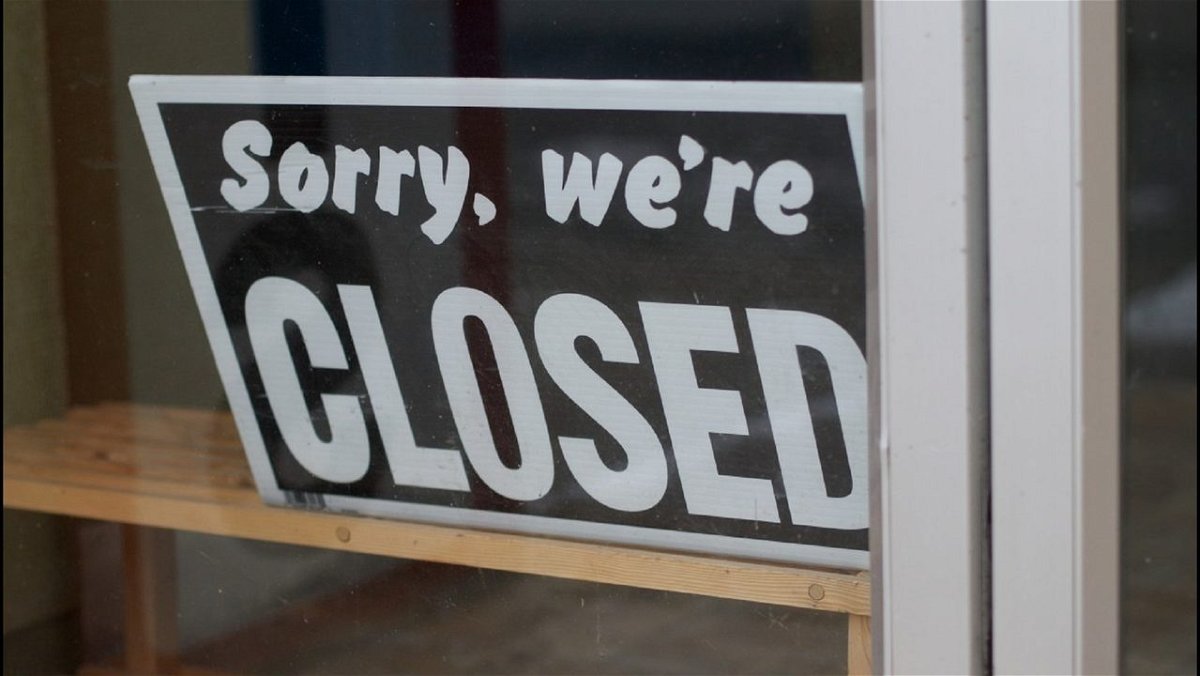 A closed sign in the window of a business.