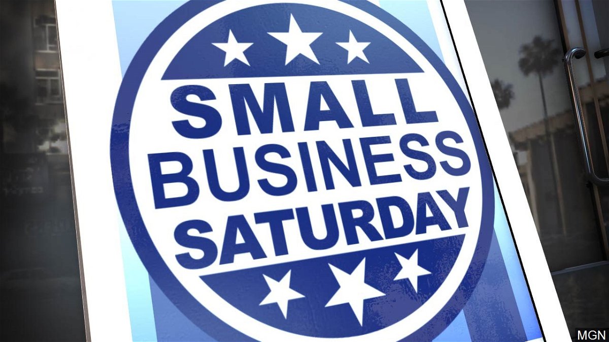 A sign in a store window promoting Small Business Saturday.