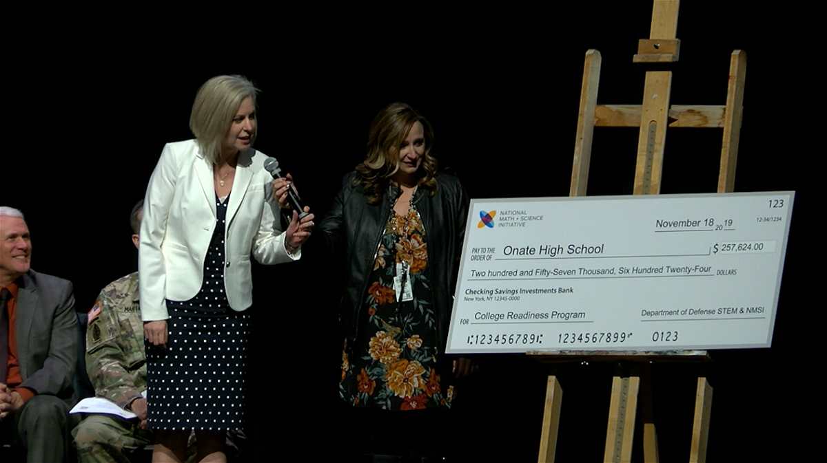 A check for more than $257,000 is presented at Oñate High School.