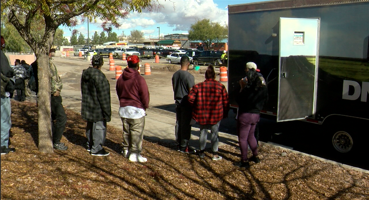 Several homeless people wait in line to get an ID at the Community of Hope in Las Cruces.