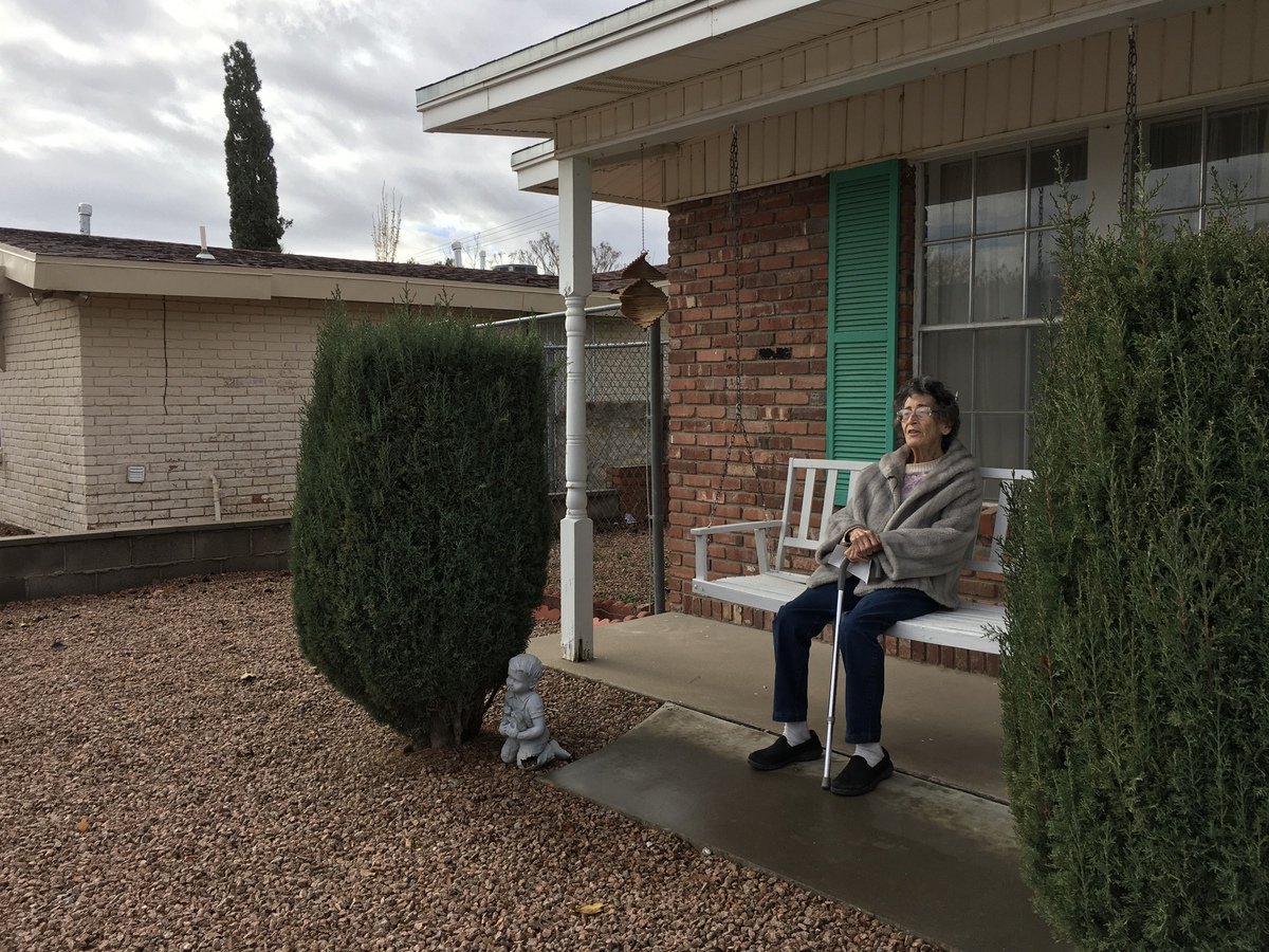 Corrine Boyce sits on her porch swing and talks about her memories of the large Afghan pine she donated to the city on behalf of her late husband in 1998. 