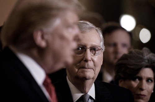 President Trump speaks as Mitch McConnell looks on.