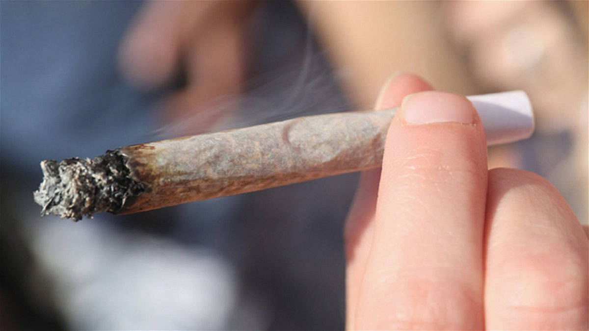 A person smokes a marijuana joint.