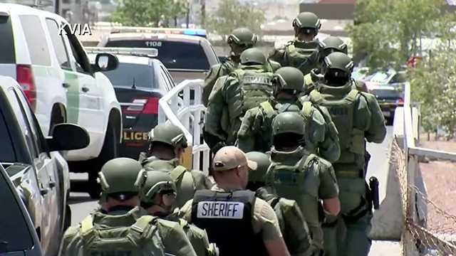 An El Paso Sheriff's deputy along with SWAT team members at the scene of the Aug. 3 Walmart mass shooting.