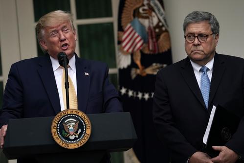 President Trump stands next to Attorney General Bill Barr at a past White House event in this file photo.