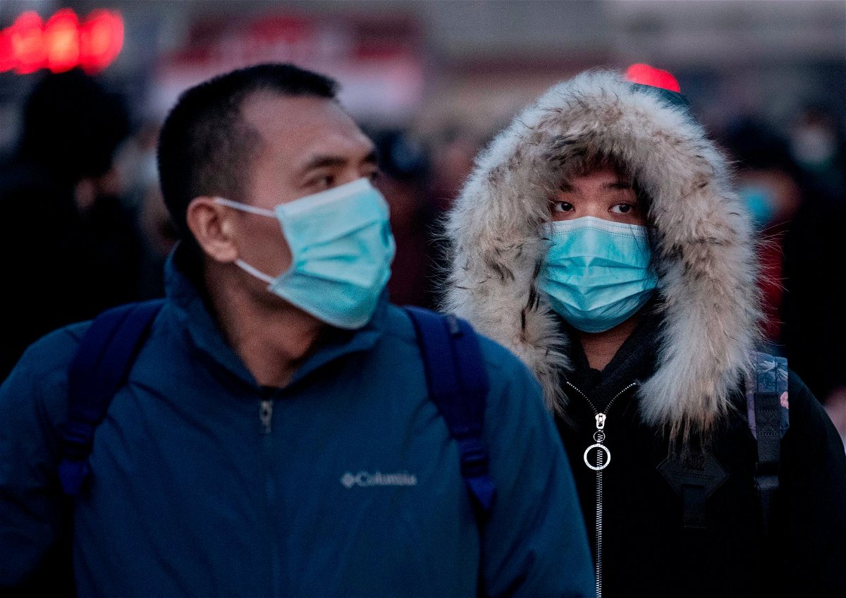 People wearing face masks out in public are seen in this file photo.