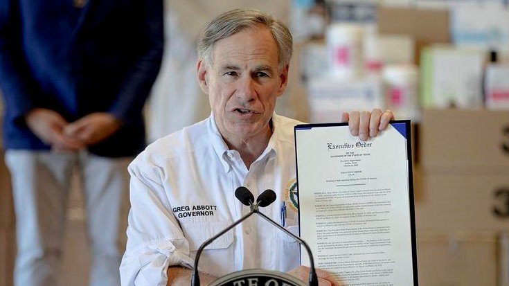 Texas Gov. Greg Abbott displays a recent executive order related to the coronavirus.