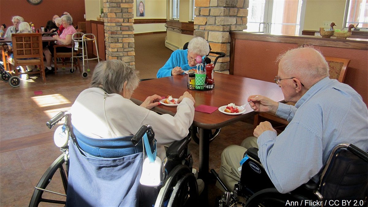 Seniors enjoy a snack at a nursing home.