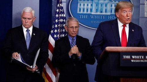 President Trump speaks as Dr. Anthony Fauci and Vice President Pence look on.