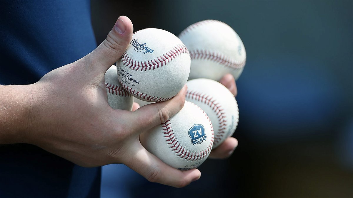 An MLB umpire holding baseballs at spring training.