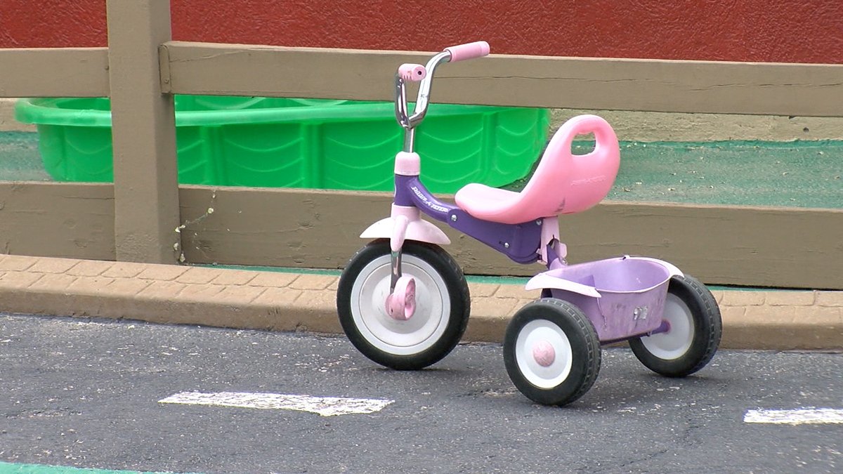 An empty child's tricycle sits outside a shuttered El Paso daycare.