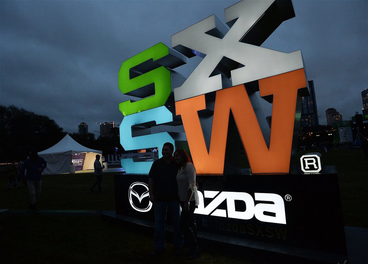 Participants stop to pose for a photo in front of a South by Southwest (SXSW) sign duging a prior year at the festival.