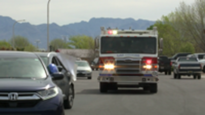 A firetruck accompanies teachers along their parade route through a Las Cruces neighborhood.