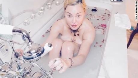 Madonna stits in her bathtub as she delivers a message on Instagram about coronavirus.