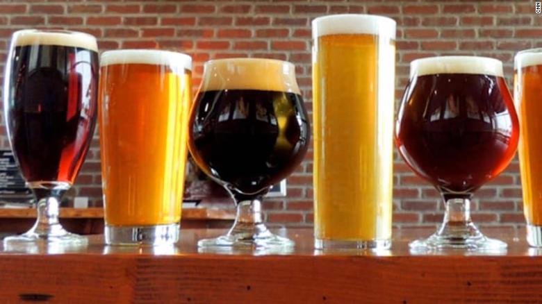A variety of craft beers are displayed in glasses.