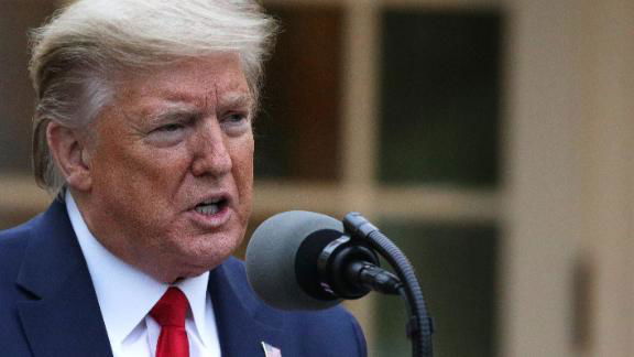 President Trump speaks during a briefing on the White House lawn.