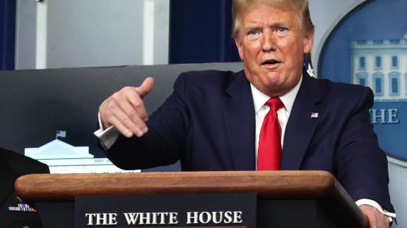 President Trump gestures to make a point during a White House briefing.