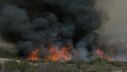 Flames from a brush fire burning near Mesilla.