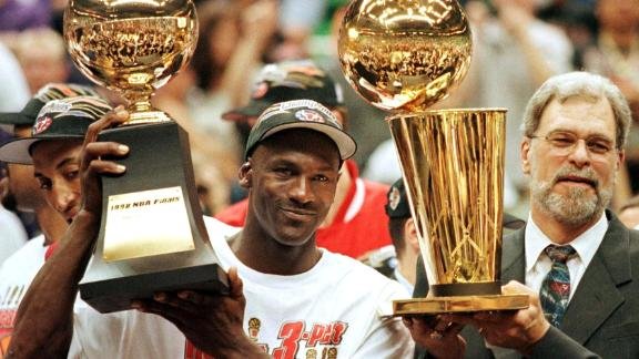 Michael Jordan seen with his  NBA championship and MVP trophies in 1998.