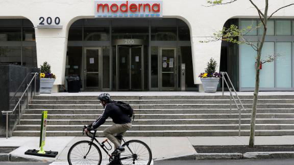 A man on a bike rides past Moderna's headquarters in Cambridge, Massachusetts.