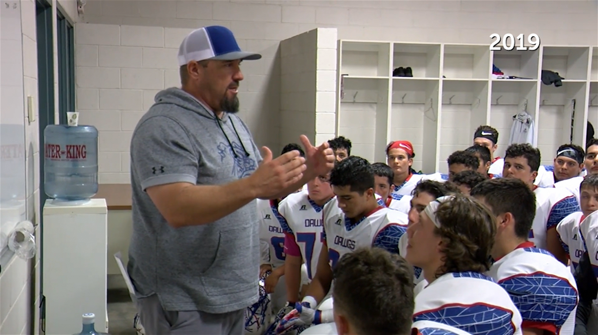Las Cruces High School football coach Mark Lopez gives a pep talk to his team ahead of a game back in 2019.