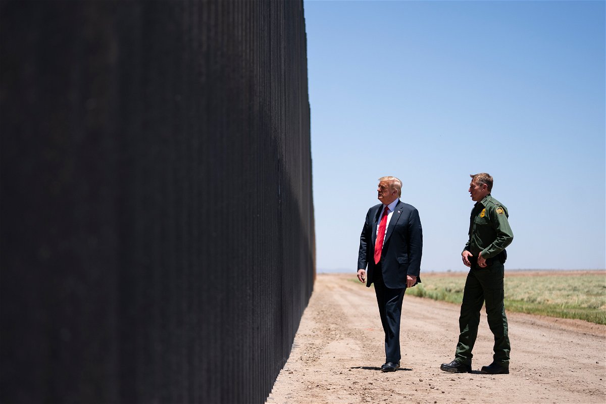 U.S. Border Patrol chief Rodney Scott gives then-President Donald Trump a tour of a section of the border wall, in San Luis, Arizona.
