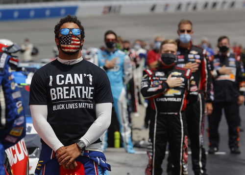 NASCAR's Bubba Wallace seen wearing an 'I can't breathe t-shirt' along with a USA face mask.