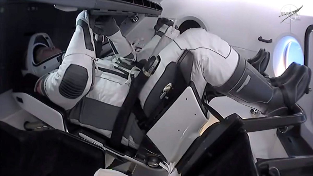Astronauts Bob Behnken and Doug Hurley inside their SpaceX Crew Dragon capsule.