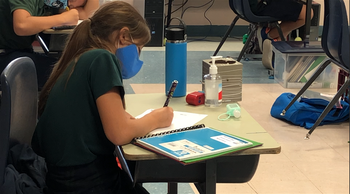 A student in class with her mask at Las Cruces Catholic School during the pandemic.