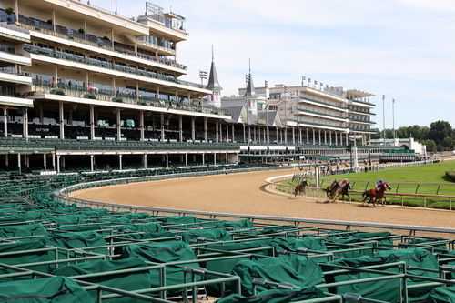 Horses run during the 146th running of the Kentucky Derby at Churchill Downs without fans inthe stands.