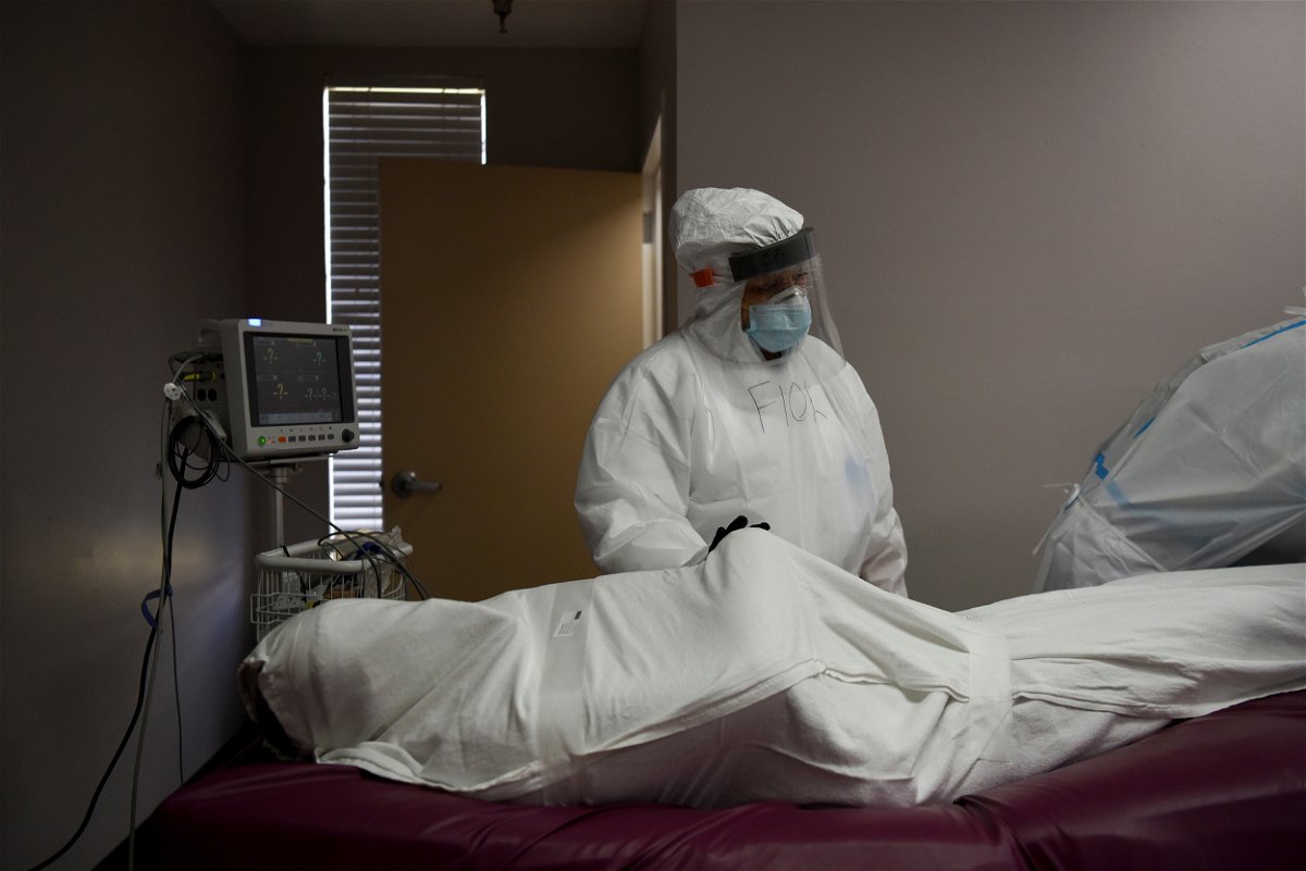 The body of a patient, who died of Covid-19 is prepared by a nurse, to be transported to a morgue from United Memorial Medical Center (UMMC) in Houston, Texas.