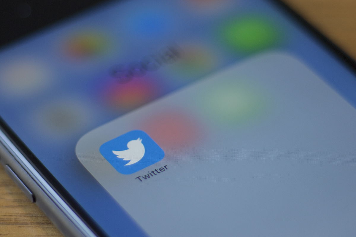 The Twitter logo is seen on a phone in this photo illustration.