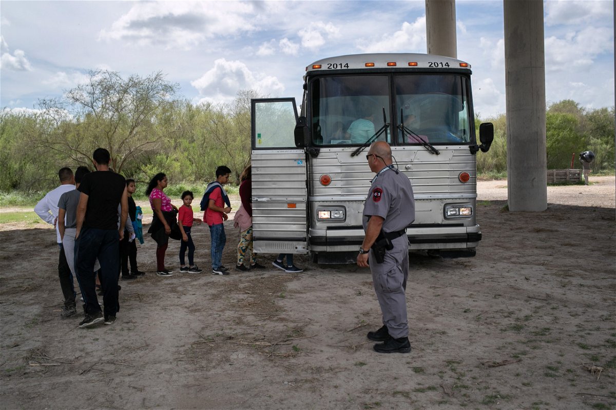 Immigrants, including children, are transported to a processing center after they were taken into custody by U.S. Border Patrol agents in McAllen, Texas.