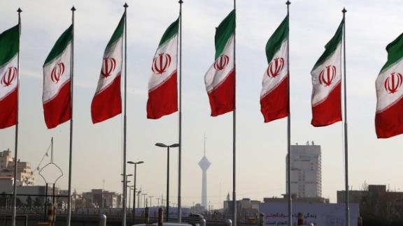 Iranian flags fly outside a government facility.