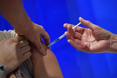 A person receives a vaccine shot.