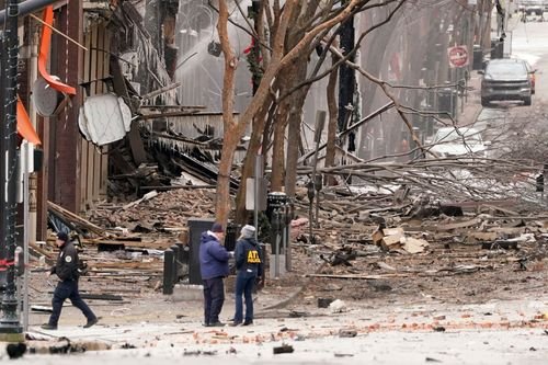Investigators stand at the scene of an explosion in Nashville, Tennessee.