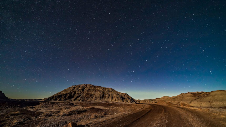 A moonlit nightscape of the badlands loop road in Dinosaur Provincial Park