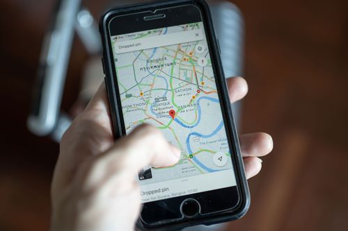 A man examines a map on his cell phone.