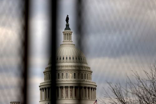 The U.S. Capitol dome is seen beyond a security fence in Washington, DC.