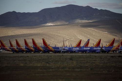 A fleet of Southwest Airlines planes sits parked.