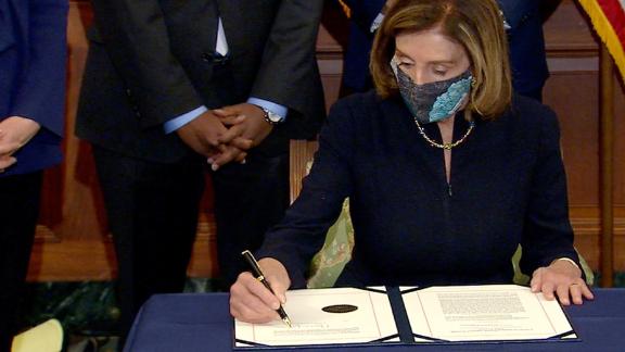 House Speaker Nancy Pelosi signs the article of impeachment against Donald Trump.