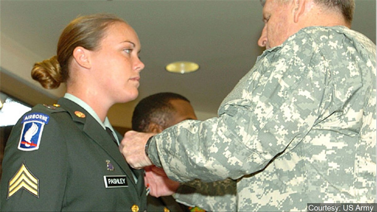 Sgt. April Pashley of the 404th Civil Affairs Battalion wears her hair back as she is  awarded the Combat Action Badge in this file photo.