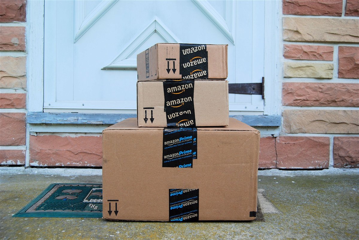 Amazon packages sit on the doorstep of a home after being delivered.