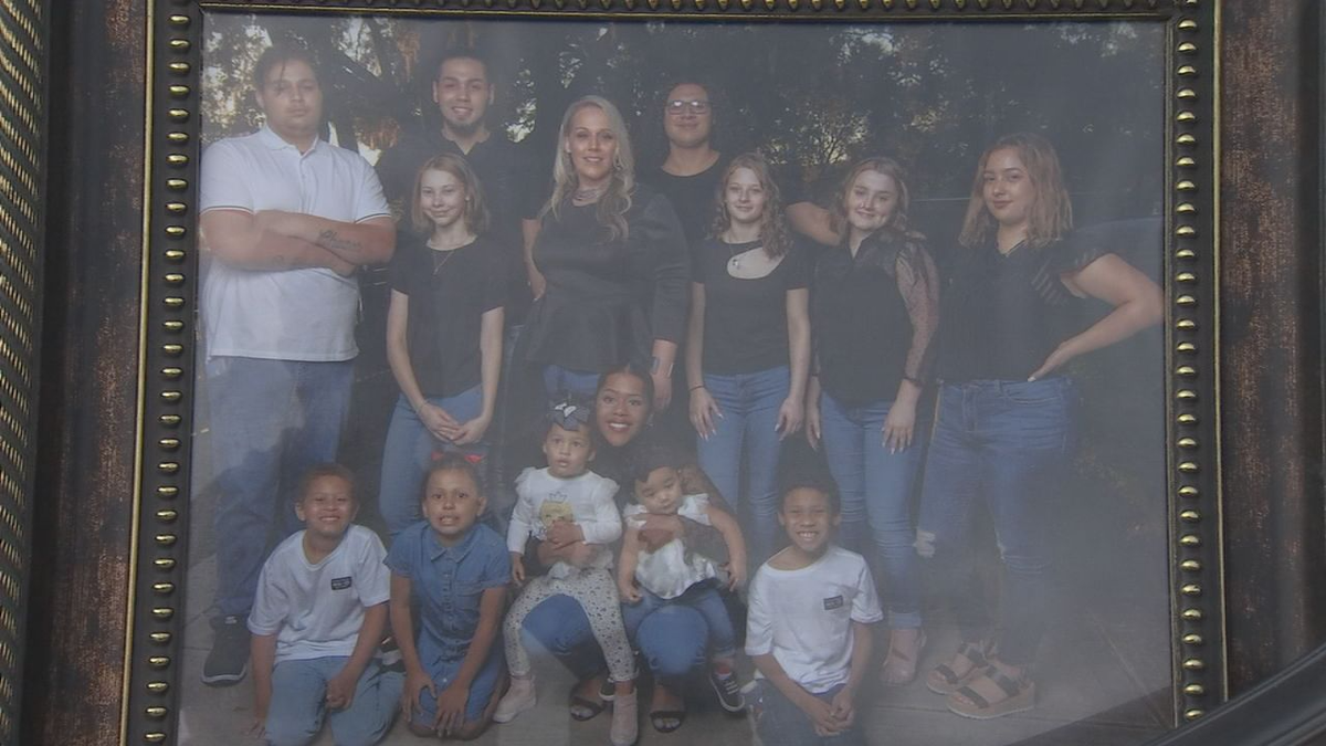 Some of a Florida woman's 300 foster children are seen a  group photo.