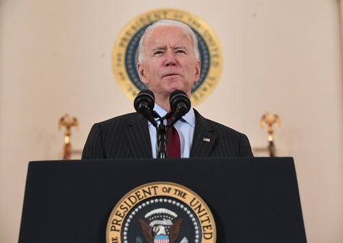 President Biden speaks from a podium at the White House.