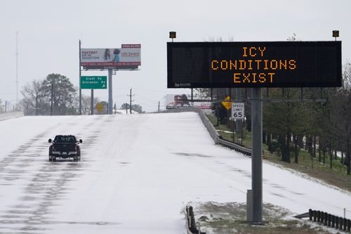 A sign warns of icy road conditions in Houston, Texas.