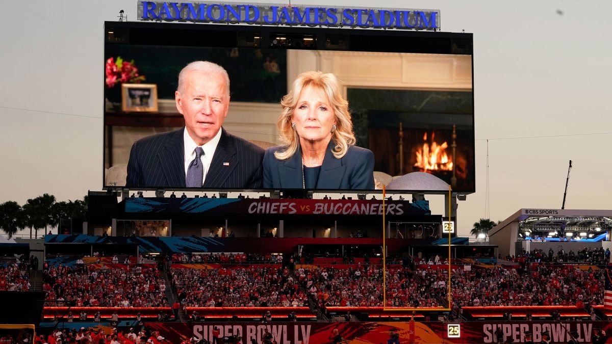 Fans watch a broadcast of President Joe Biden and first lady Jill Biden during Super Bowl 55.