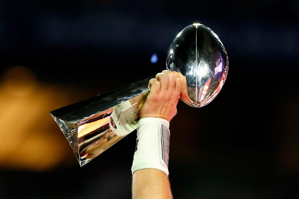 Tom Brady celebrates holding the Vince Lombardi Trophy after winning last year's Super Bowl.